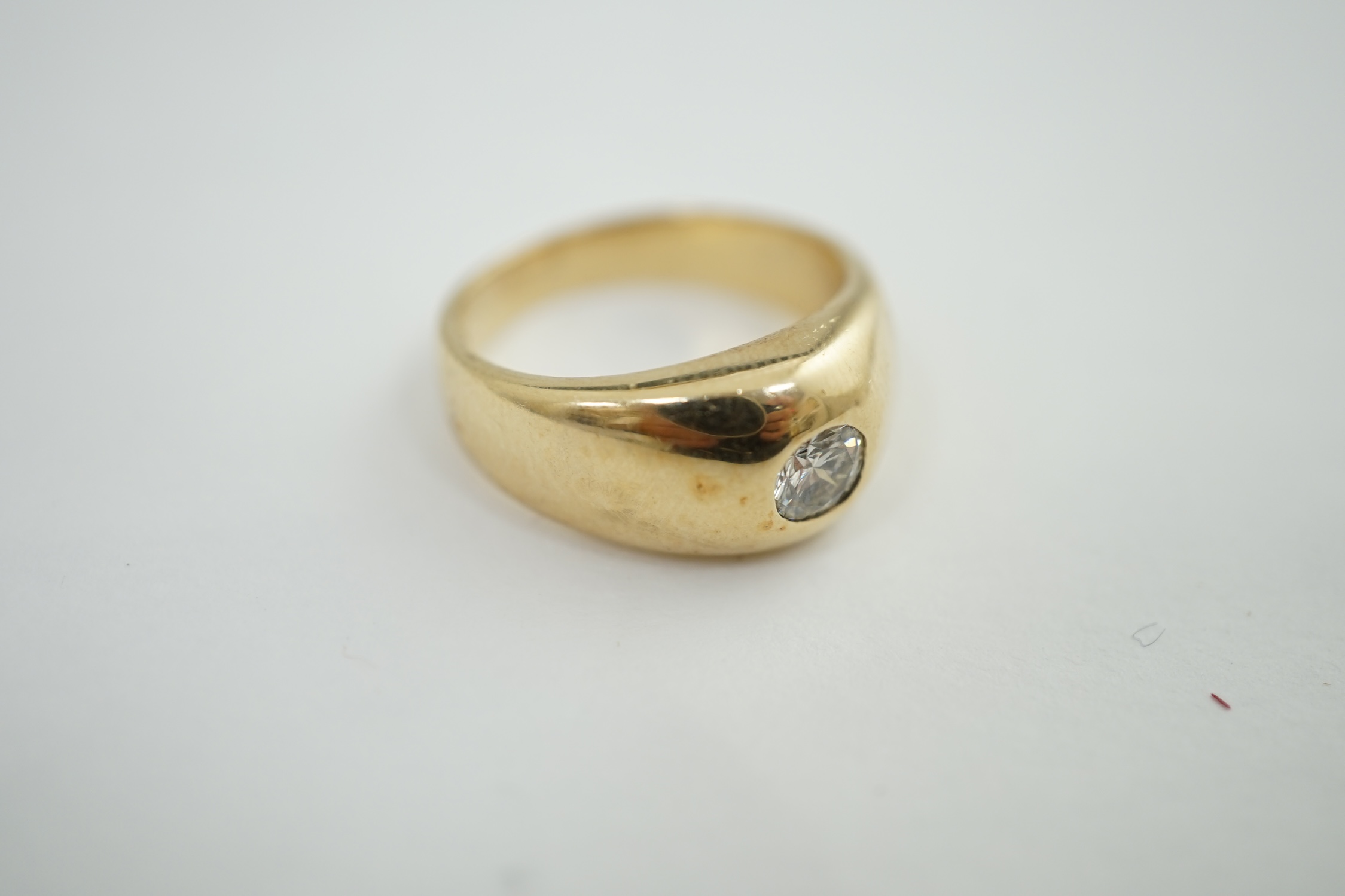 A modern 9ct gold and collet set solitaire diamond ring